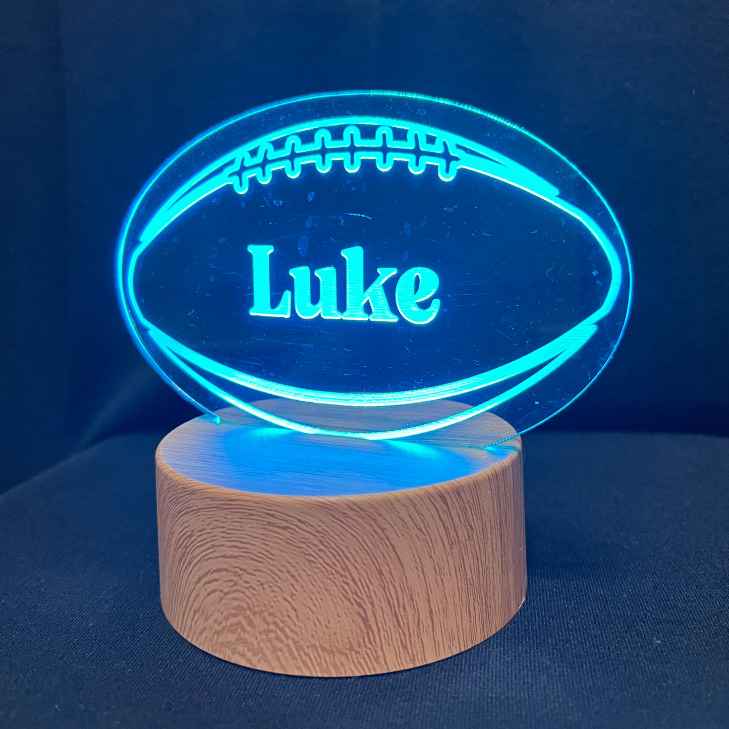 Football Name Night Light – Personalized LED night light featuring an engraved football design with a custom name in the center, glowing warmly for football players and fans.