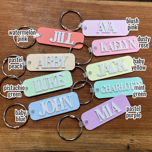 colorful bag tags with names on them and words to correspond with each color