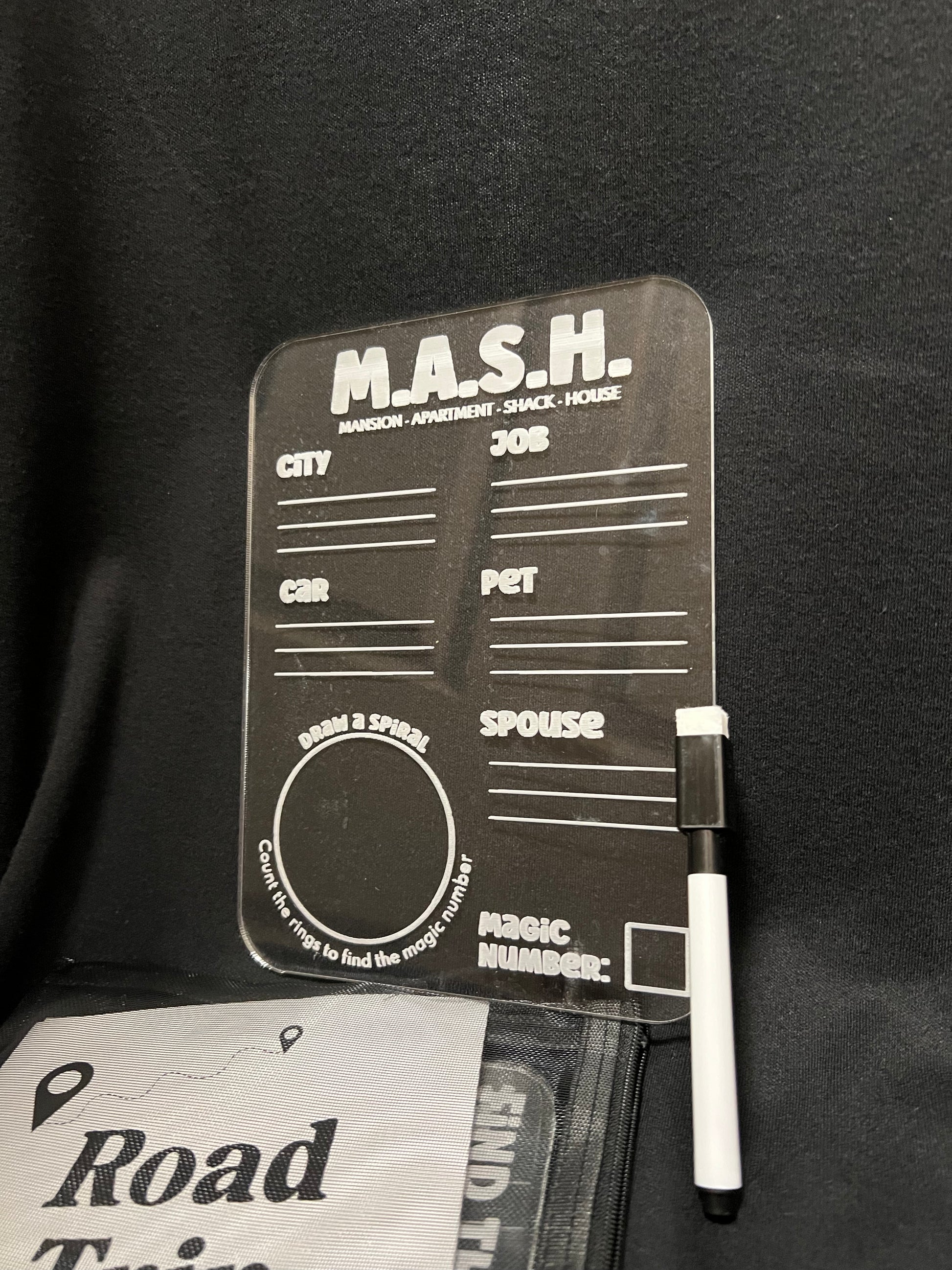 M.A.S.H. form with pen on a black background