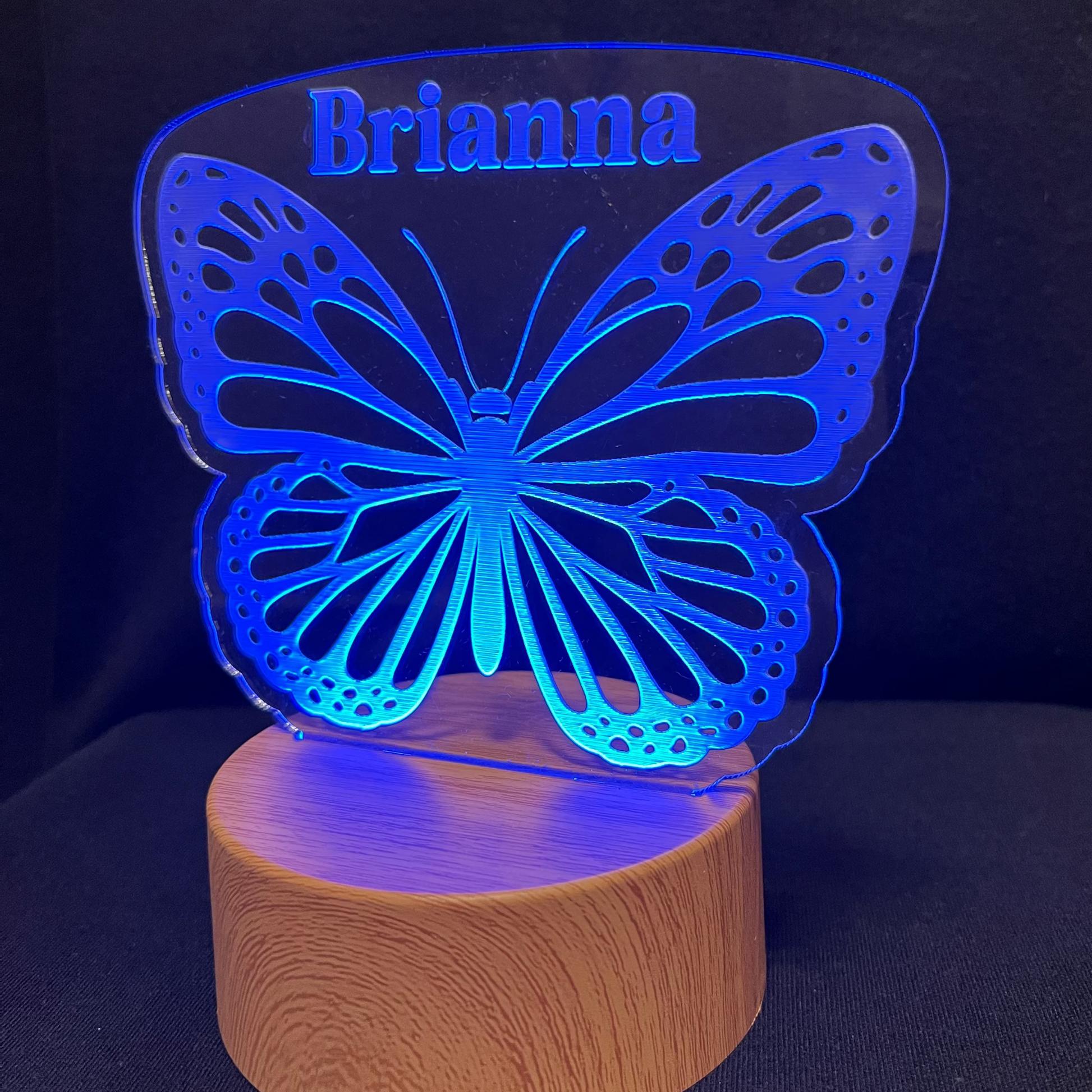 Butterfly-shaped night light with 'Brianna' on a dark background
