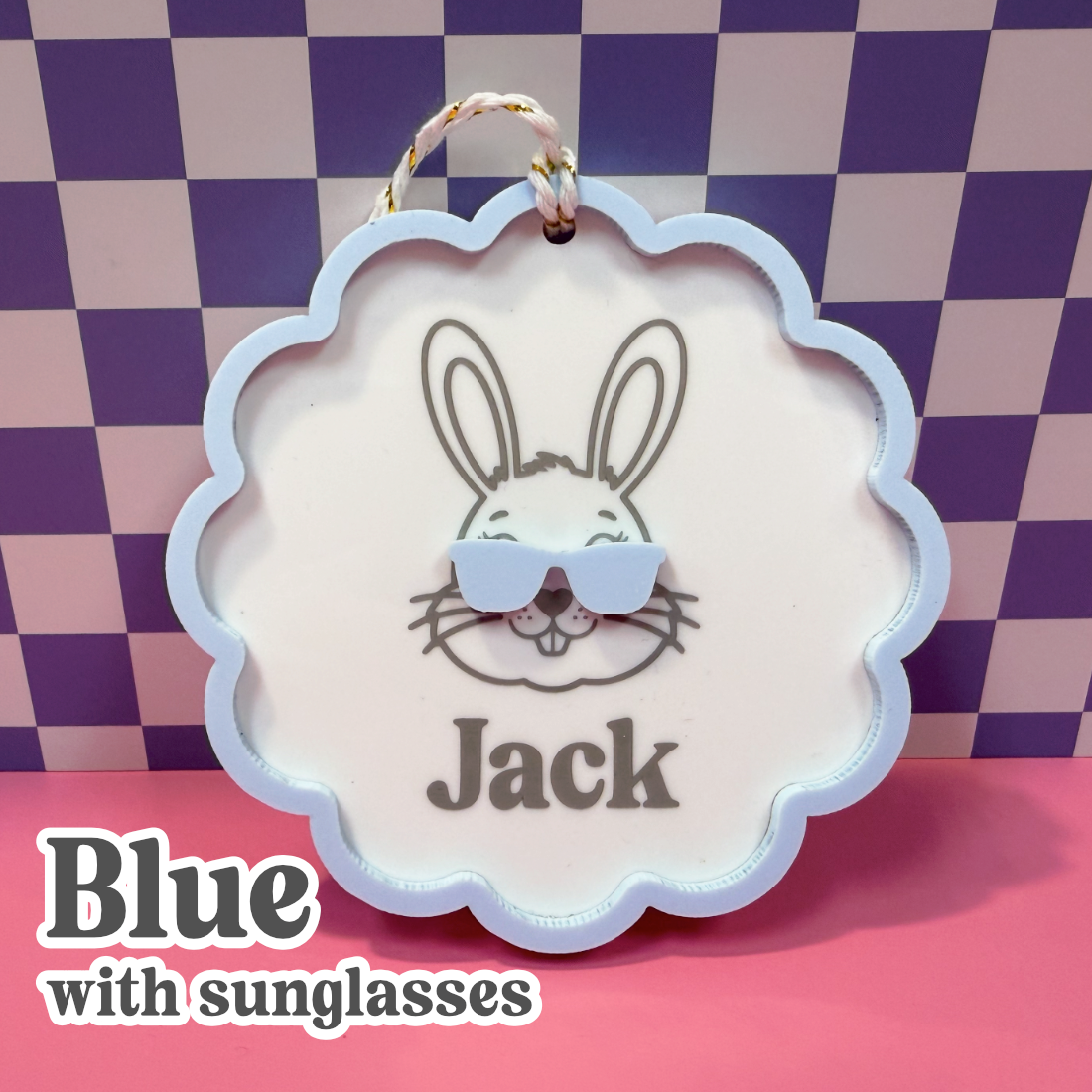 Decorative sign with a rabbit illustration and 'Jack' text, against a checkered background.