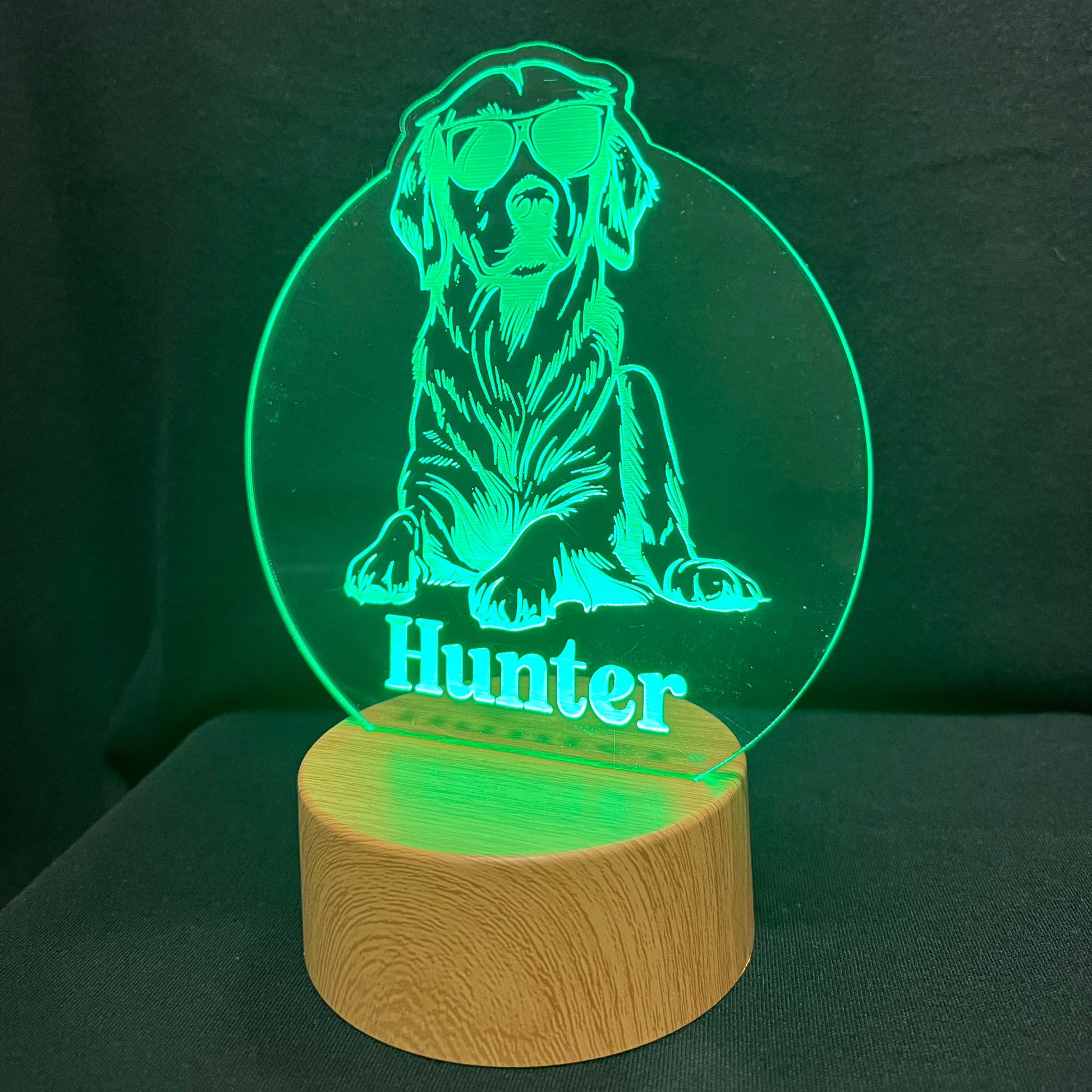 Personalized dog nightlight featuring a cool dog wearing sunglasses, with a custom name engraved below, glowing softly in a warm LED light.