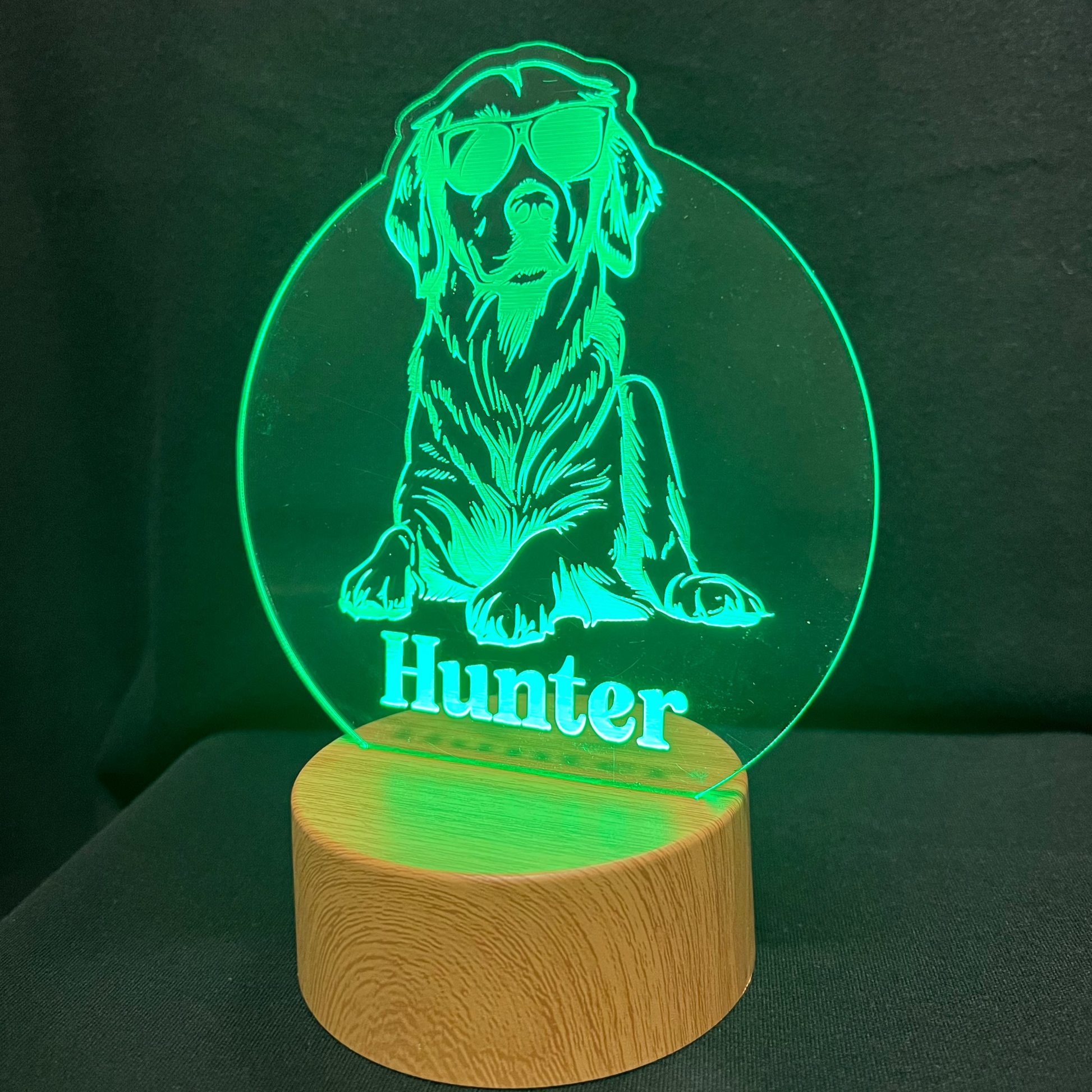 Personalized dog nightlight featuring a cool dog wearing sunglasses, with a custom name engraved below, glowing softly in a warm LED light.