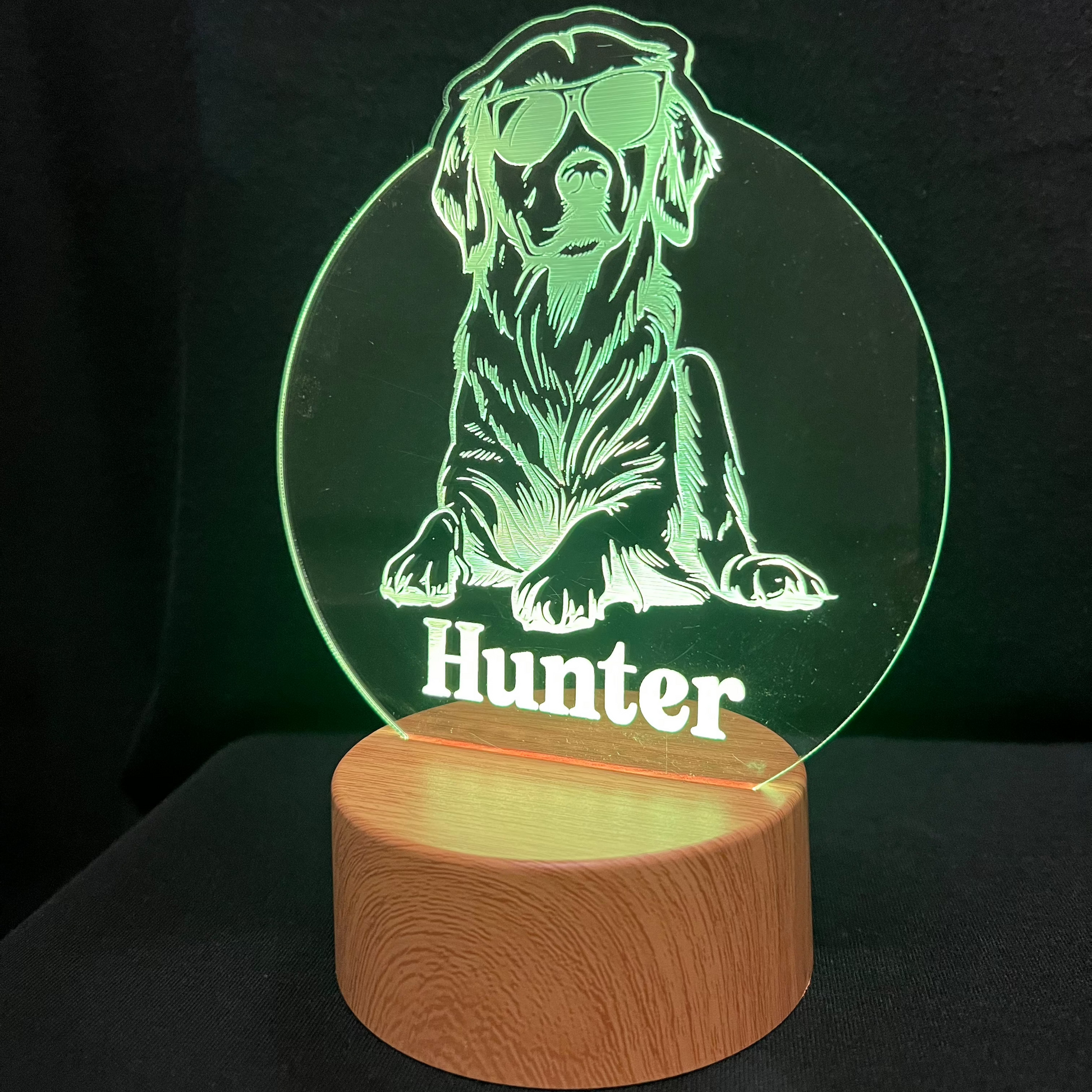 Personalized dog nightlight featuring a cool dog wearing sunglasses, with a custom name engraved below, glowing softly in a warm LED light.