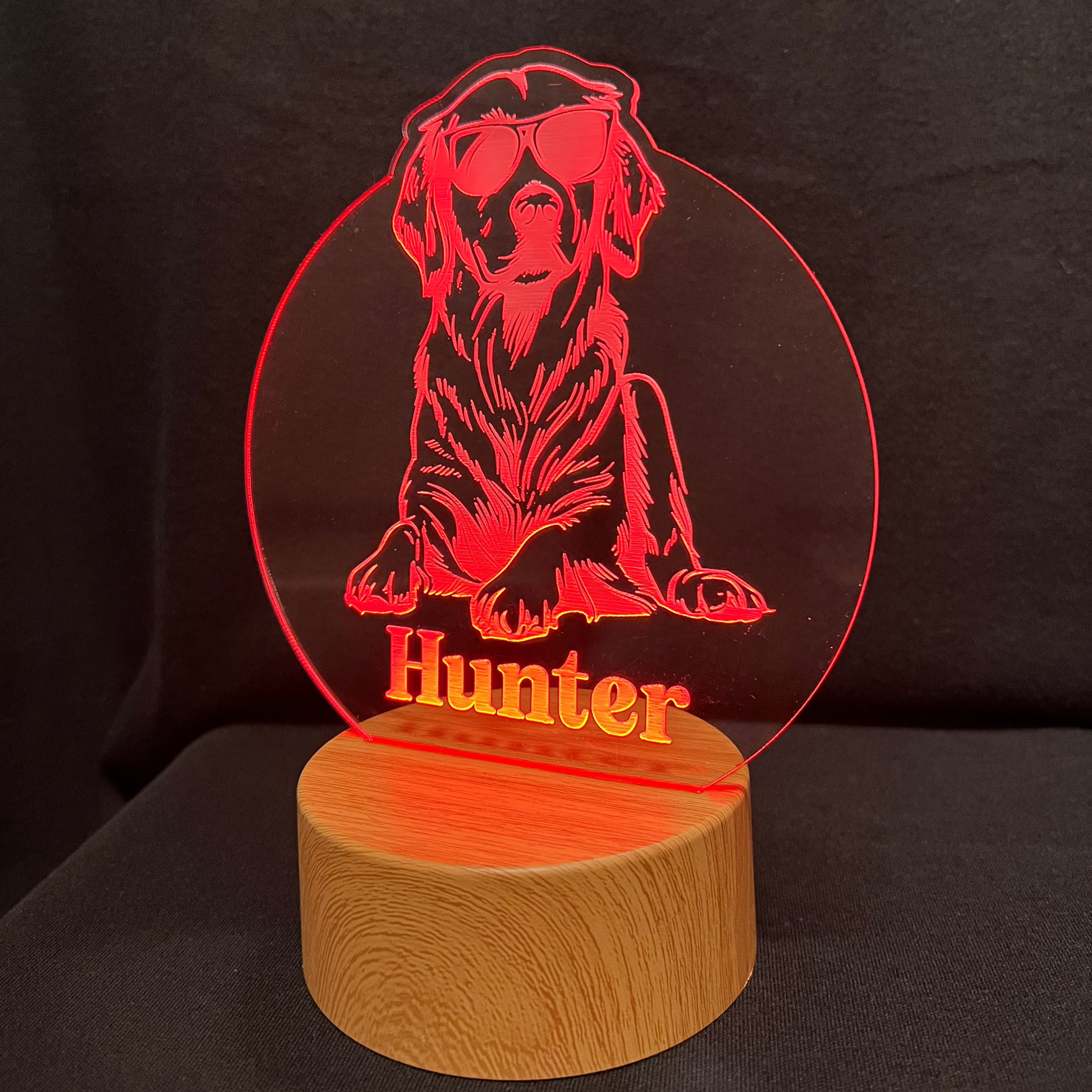 Personalized dog nightlight featuring a cool dog wearing sunglasses, with a custom name engraved below, glowing softly in a warm LED light.