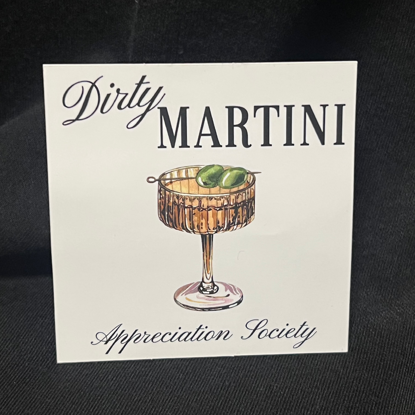 Sticker with the text 'Dirty Martini Appreciation Society' featuring an illustration of a classic martini glass filled with a dirty martini, garnished with green olives