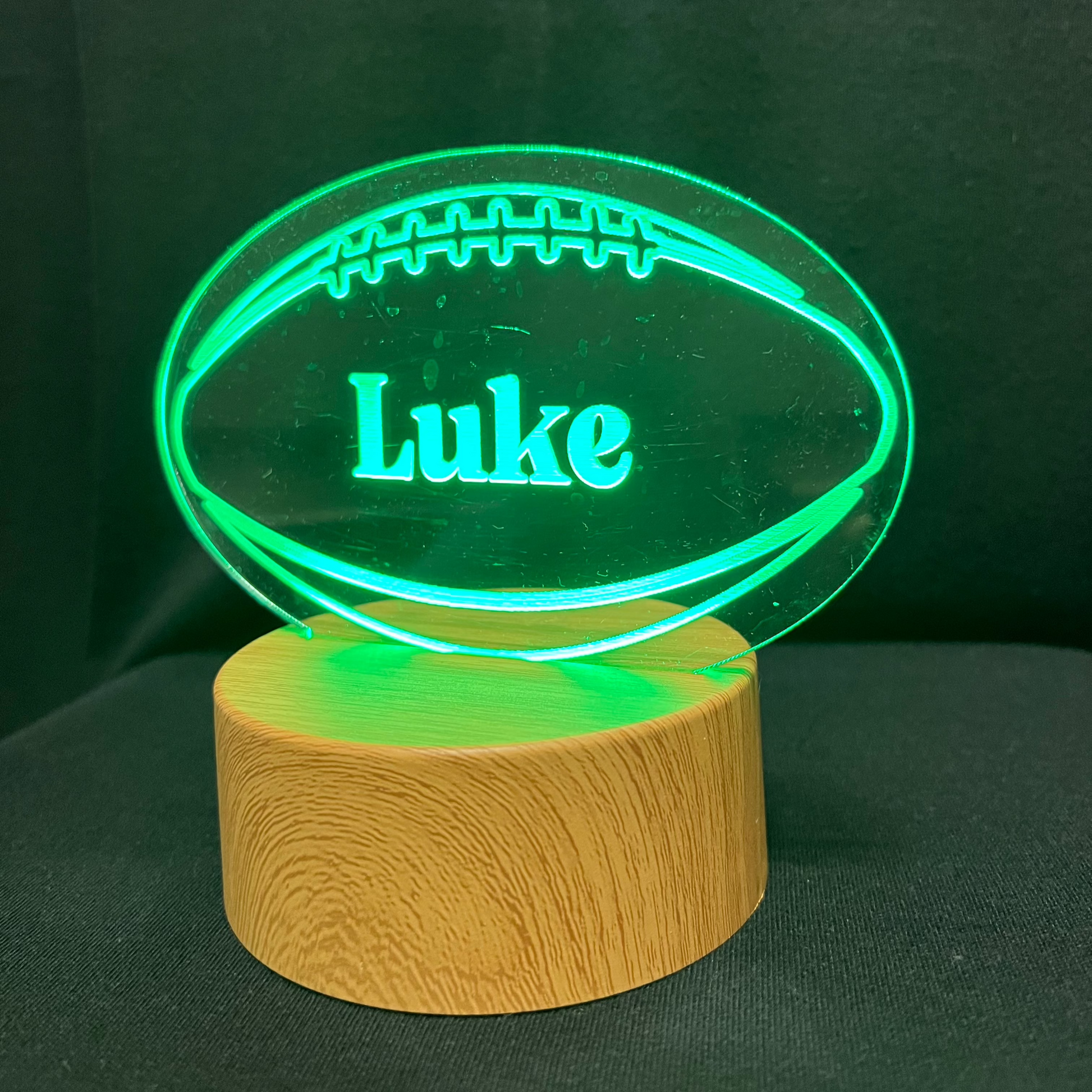 Football Name Night Light – Personalized LED night light featuring an engraved football design with a custom name in the center, glowing warmly for football players and fans.