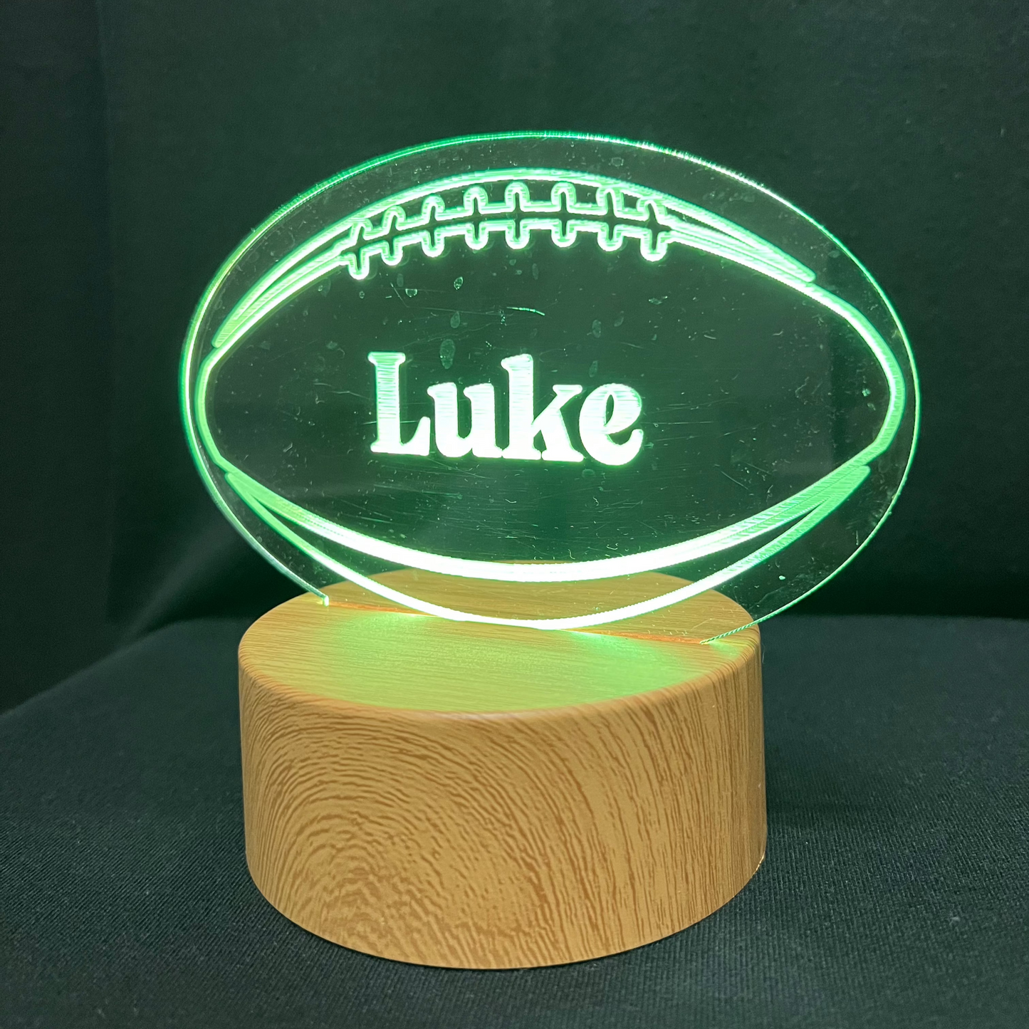 Football Name Night Light – Personalized LED night light featuring an engraved football design with a custom name in the center, glowing warmly for football players and fans.
