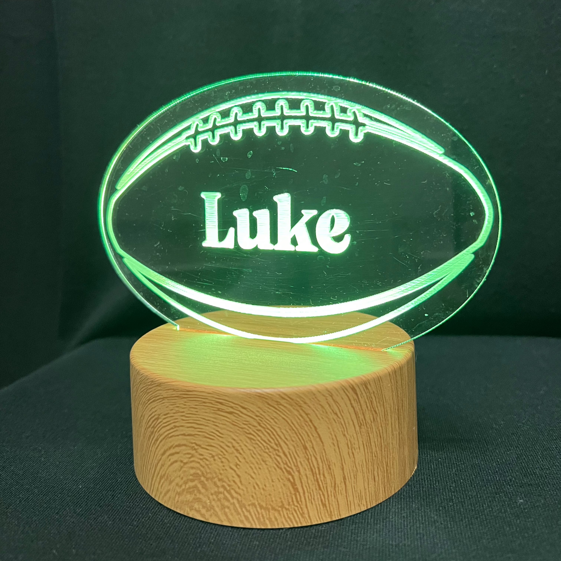 Football Name Night Light – Personalized LED night light featuring an engraved football design with a custom name in the center, glowing warmly for football players and fans.
