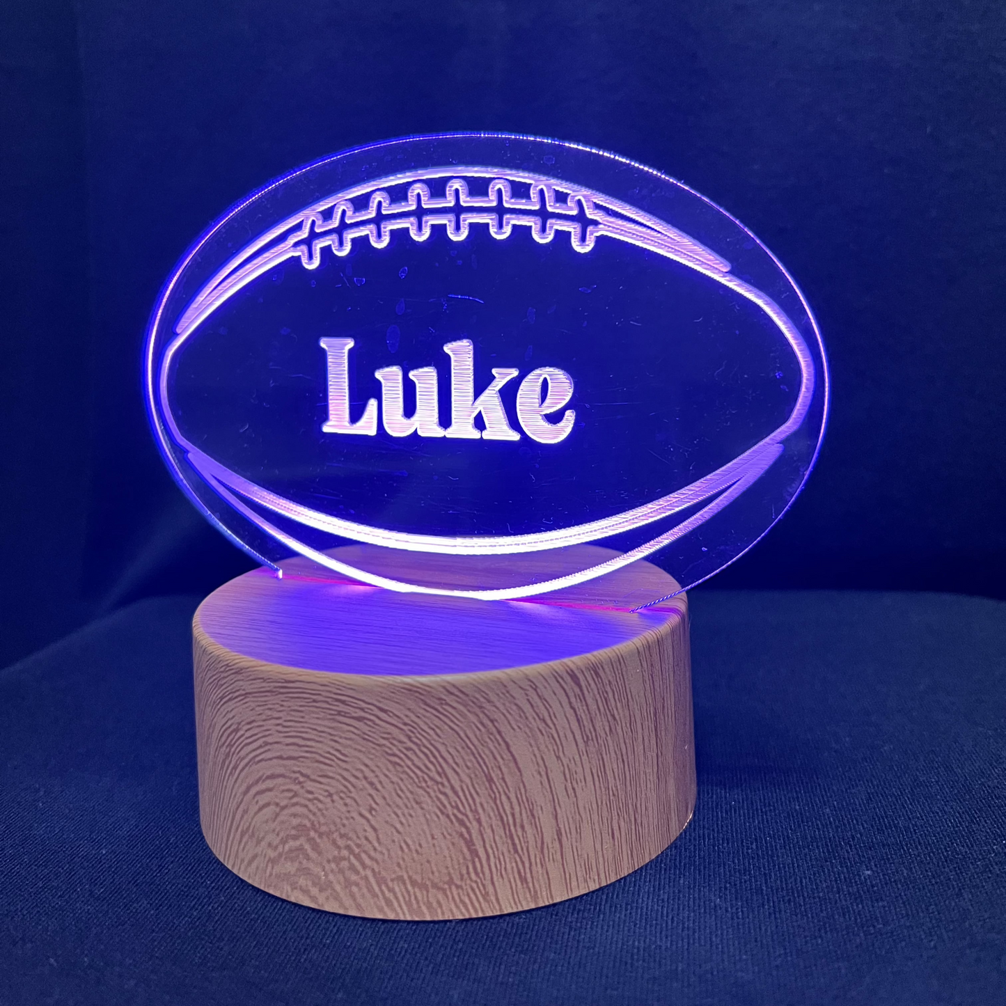 Football Name Night Light – Personalized LED night light featuring an engraved football design with a custom name in the center, glowing warmly for football players and fans.
