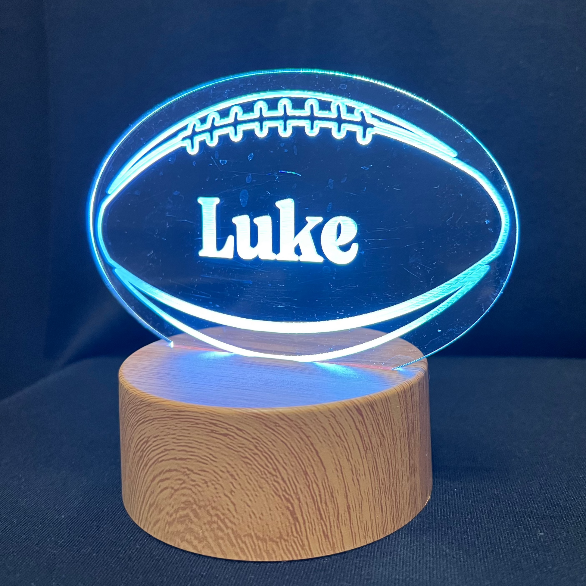 Football Name Night Light – Personalized LED night light featuring an engraved football design with a custom name in the center, glowing warmly for football players and fans.