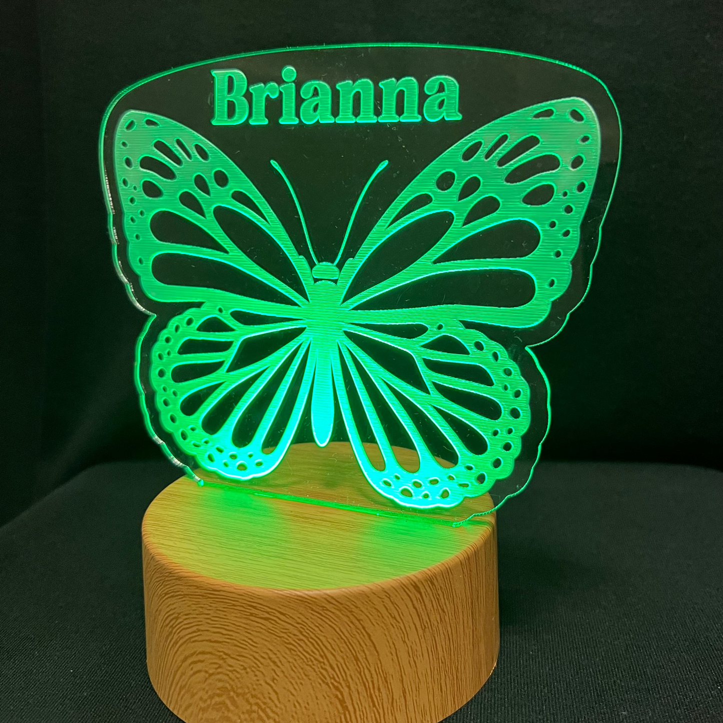 Butterfly-shaped night light with 'Brianna' engraved on a dark background