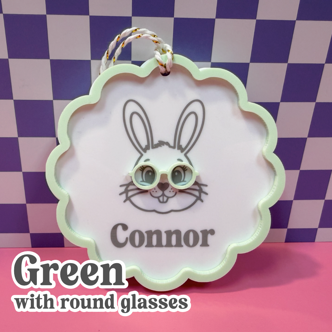 Decorative tag with a rabbit design and the name 'Connor' on a checkered background.