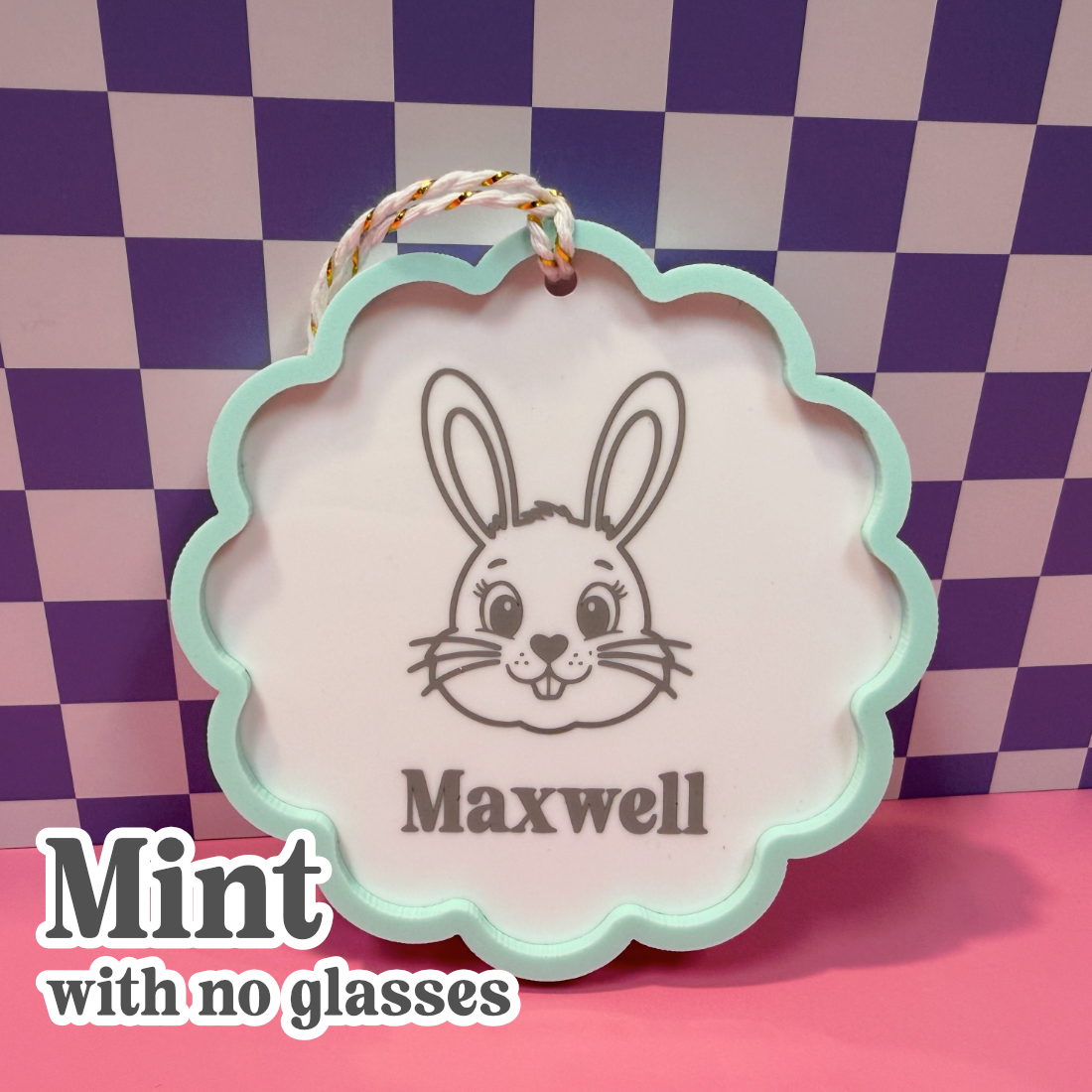 Decorative tag with a rabbit illustration and the name 'Maxwell' against a checkered background.