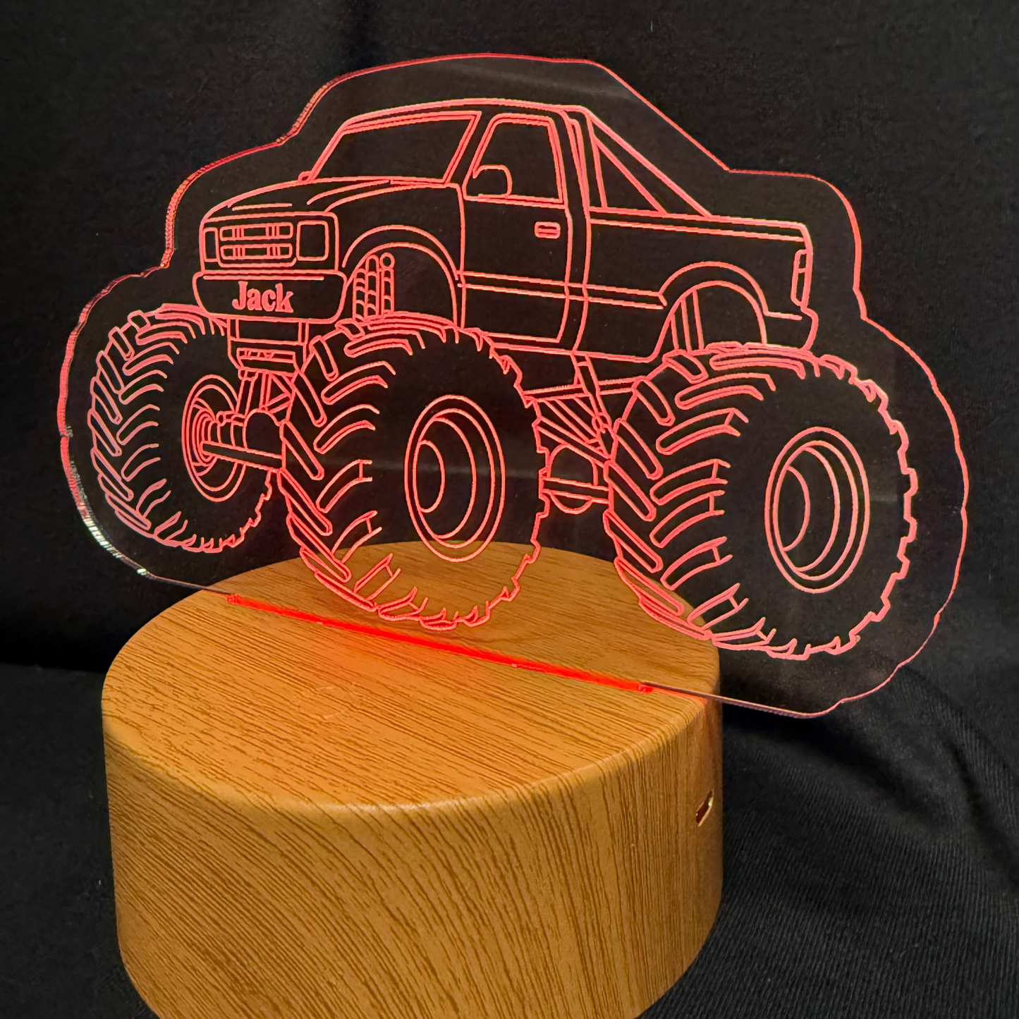 Monster truck design on a black shirt with a wooden base