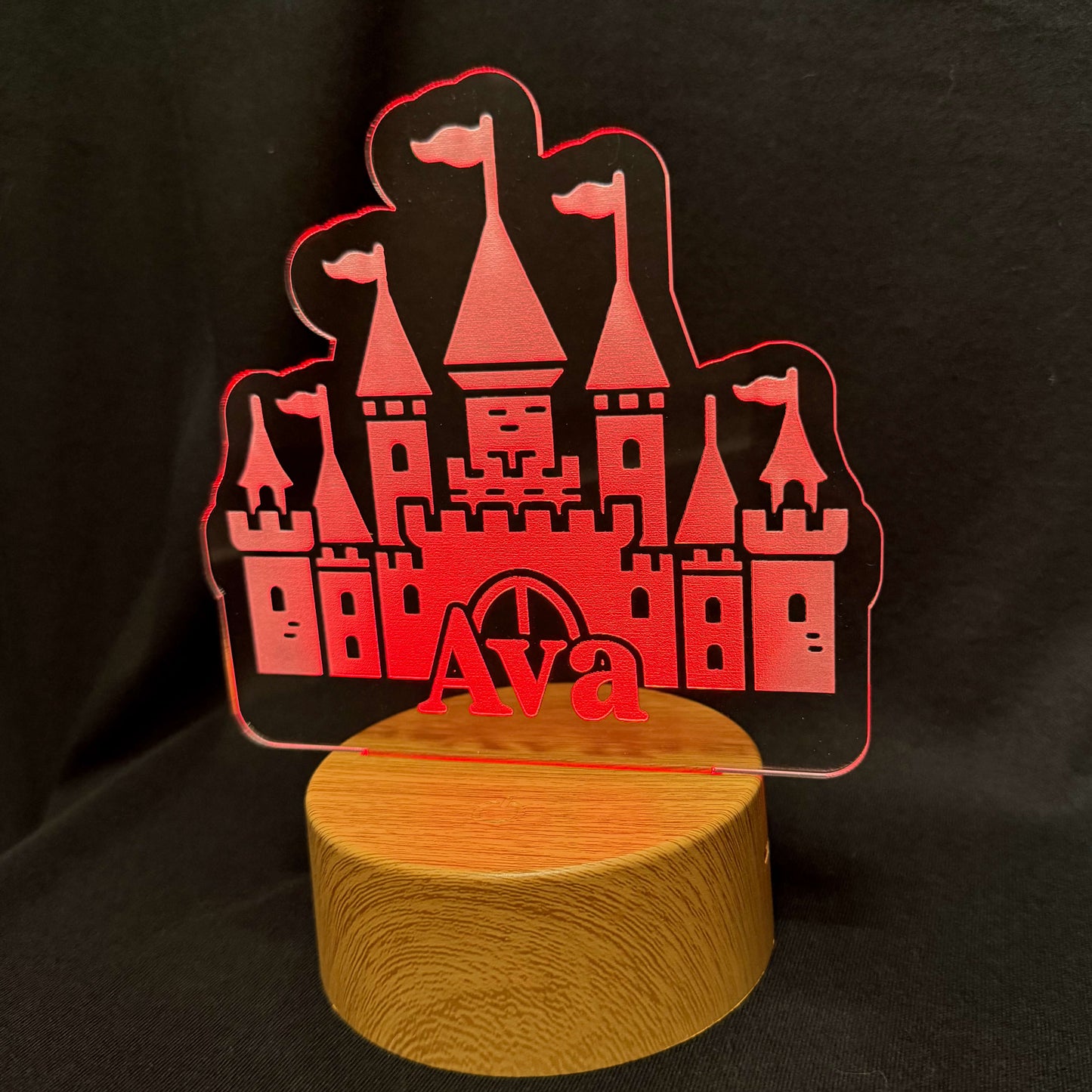 Decorative lamp with castle design and 'Ava' text on a black background