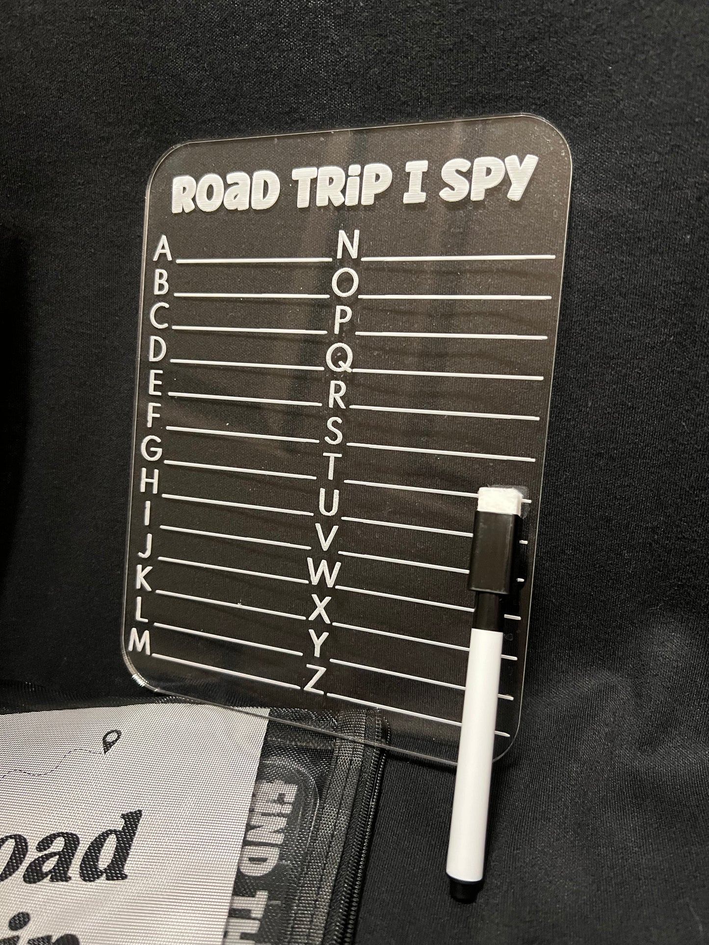 Road trip I Spy game board with pen on a black background