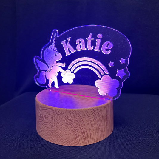 Unicorn Name Night Light – Personalized LED night light featuring an engraved unicorn with a rainbow and stars, glowing softly around a custom name for a magical, dreamy touch