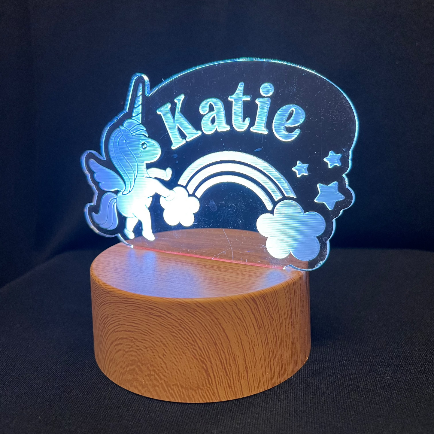 Unicorn Name Night Light – Personalized LED night light featuring an engraved unicorn with a rainbow and stars, glowing softly around a custom name for a magical, dreamy touch